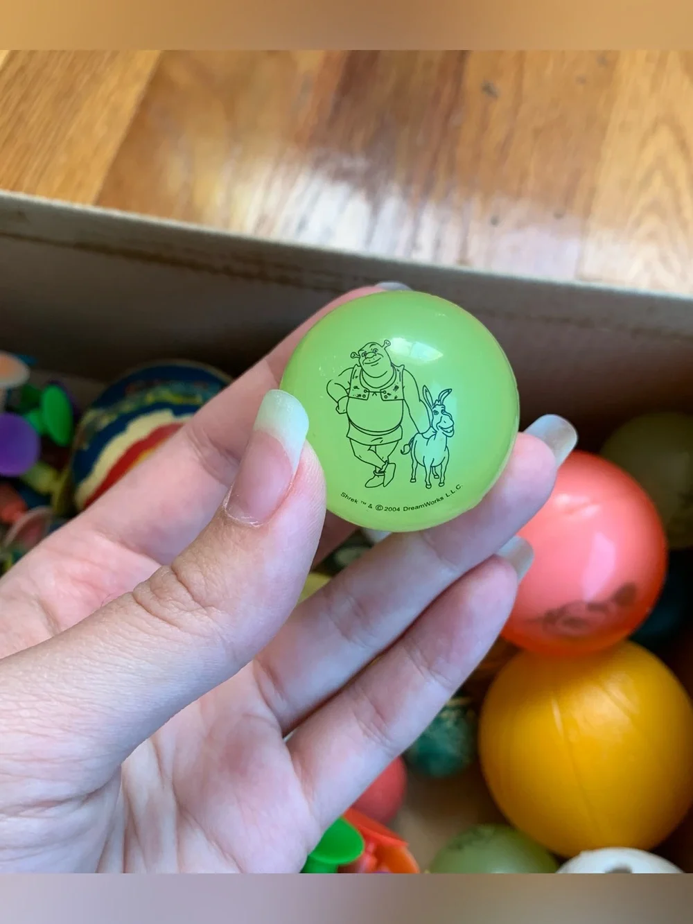 Box of assorted rubber balls, including bouncy balls and vintage Y2K balls